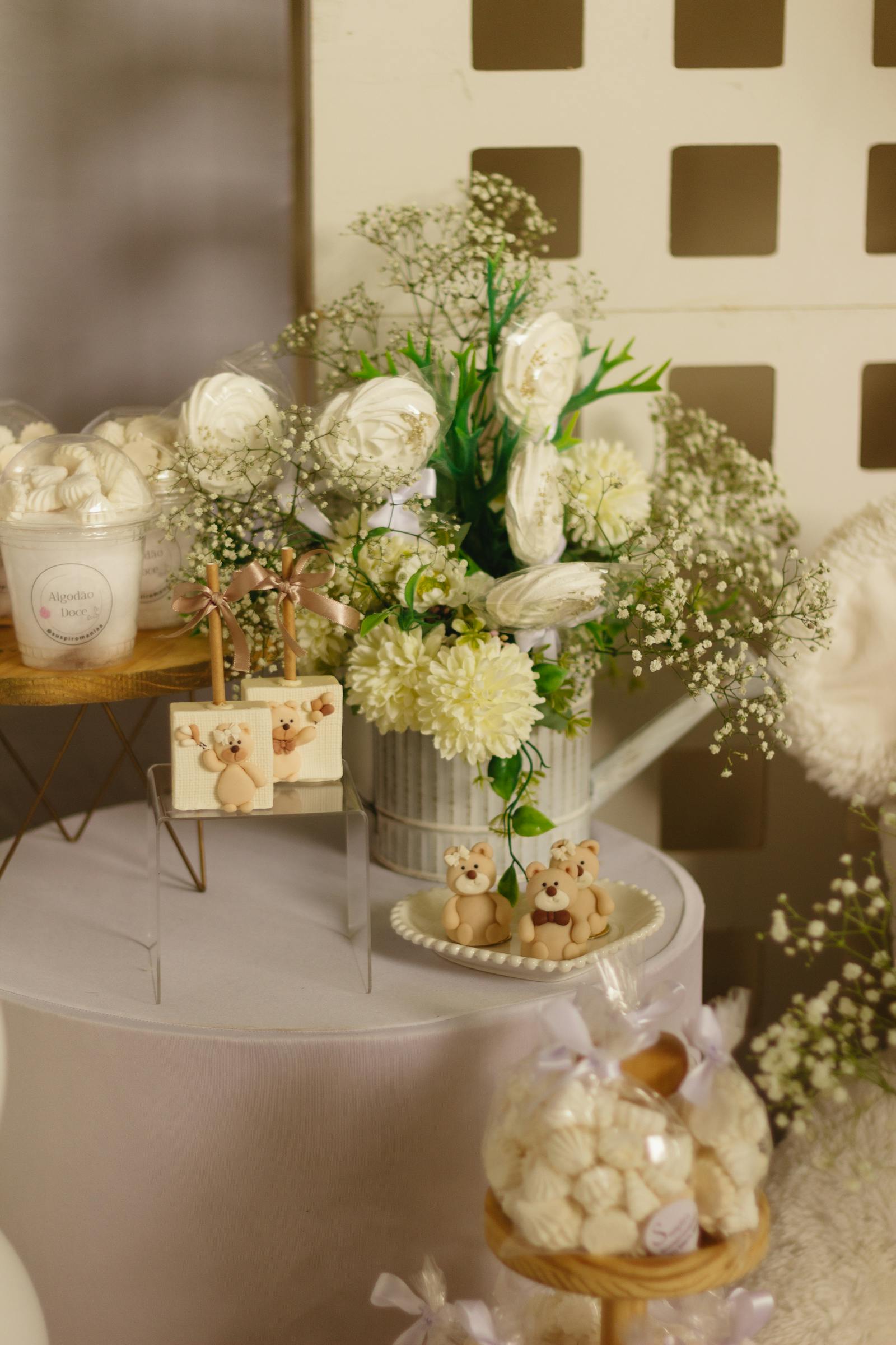Elegant white floral arrangement with baby's breath and teddy bear figurines