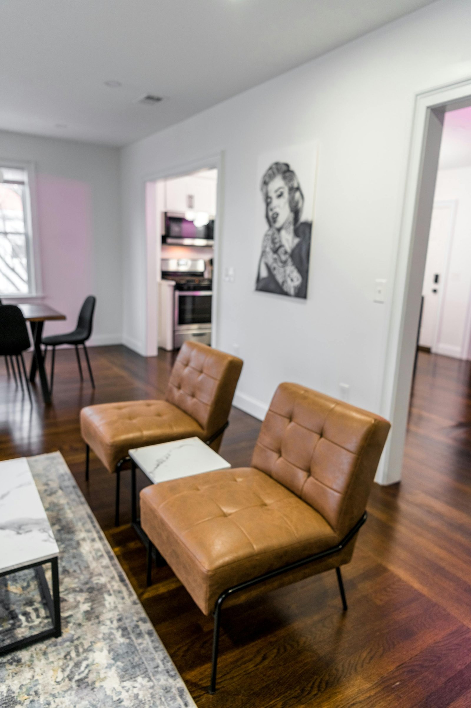 Modern vacation rental living room with leather chairs and open kitchen