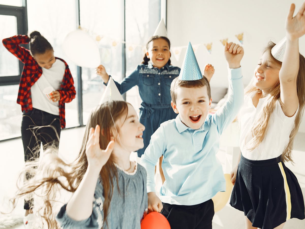 Kids cheering together at a birthday party