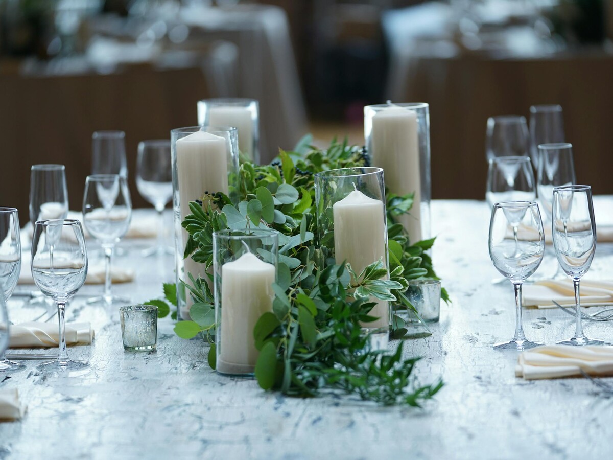 Warm candlelight and greenery on a styled table