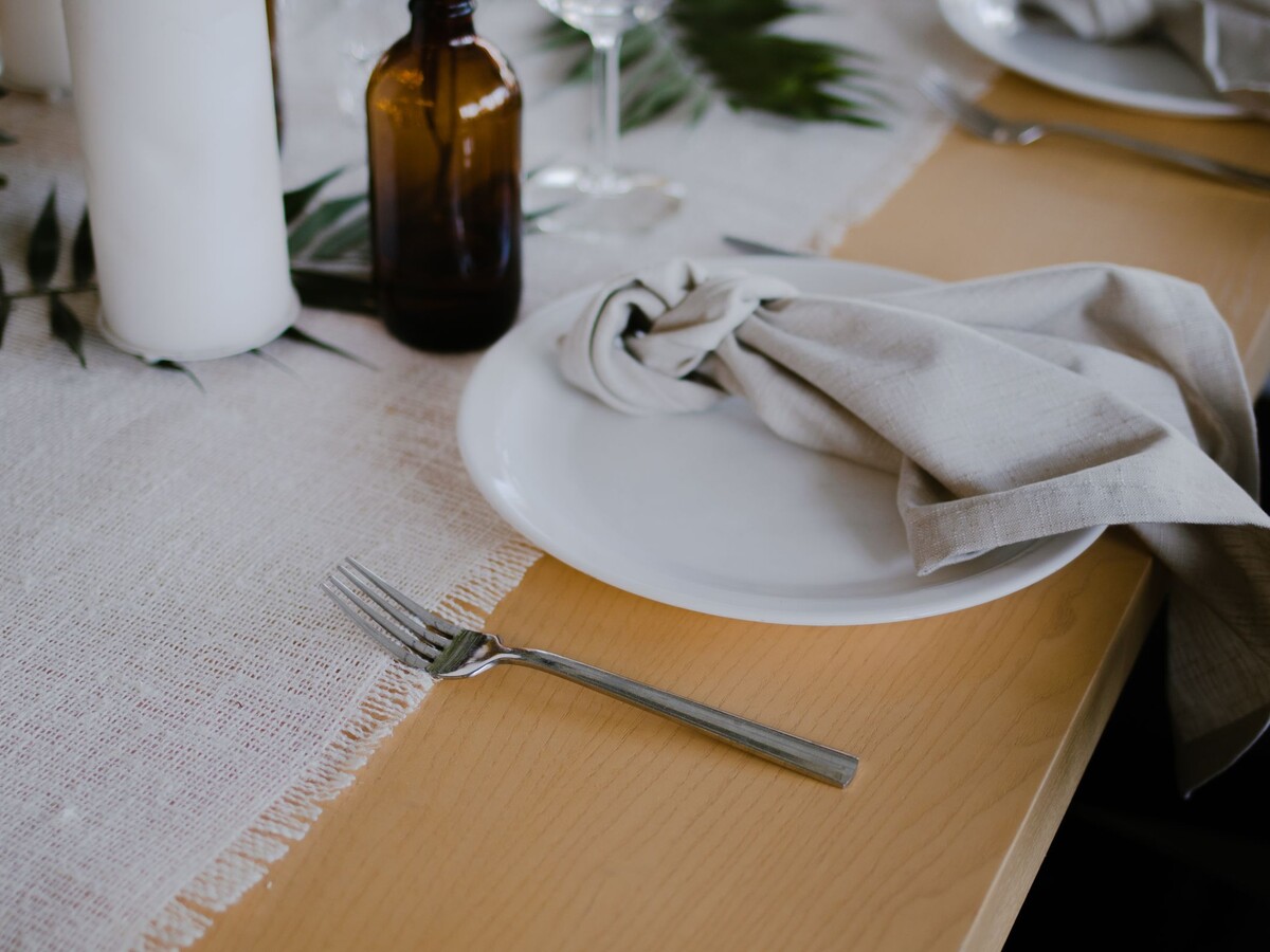 Layered linen and runner tablescape detail